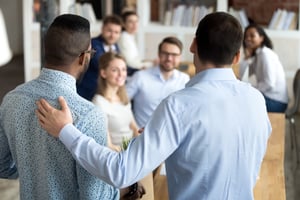 Man welcomes new employee to office